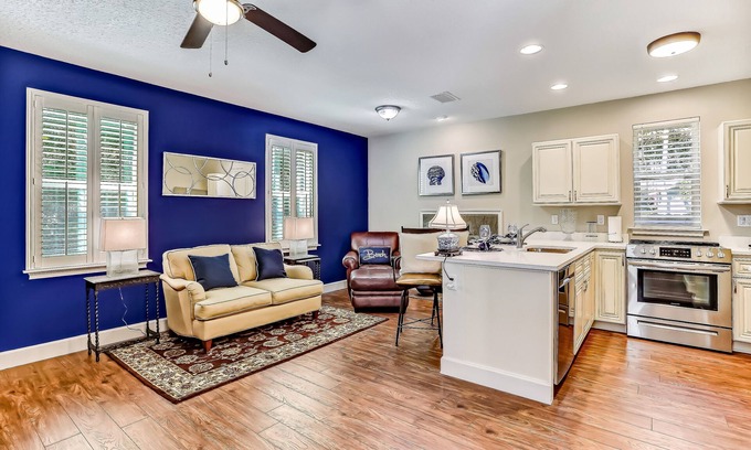 American Beach Condo | Stylish & sun-filled retreat with large patio & fireplace - near beaches & golf