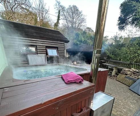 Foxdale House | The hot tub by the waterfall - facilities included