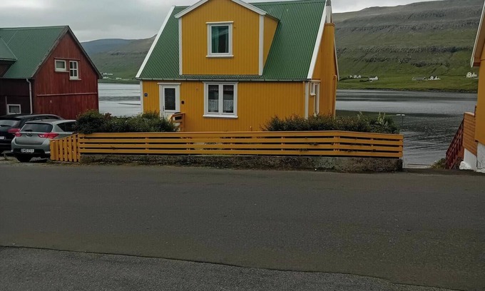 Trongisvagur Villa | The Little Yellow House Cozy Old Faroese wooden house.