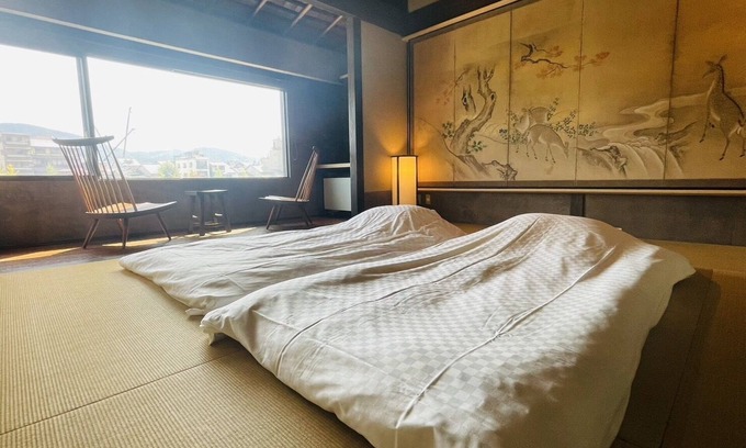 Karasuma House | This is a single building rental of a Kyomachiya that has been in existence since the Meiji Era (1868-1912). The window overlooks the Kamo River and the town of Gion, making it a prime location to enjoy the typical Kyoto scenery.