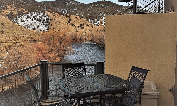 Salida Condo | This riverfront downtown condo boasts and open floor plan for kitchen, living room, and dining areas. Or step onto the balcony over the Arkansas River to hear the water rushing by. Oversized master suite has its own balcony and indoor sitting area.