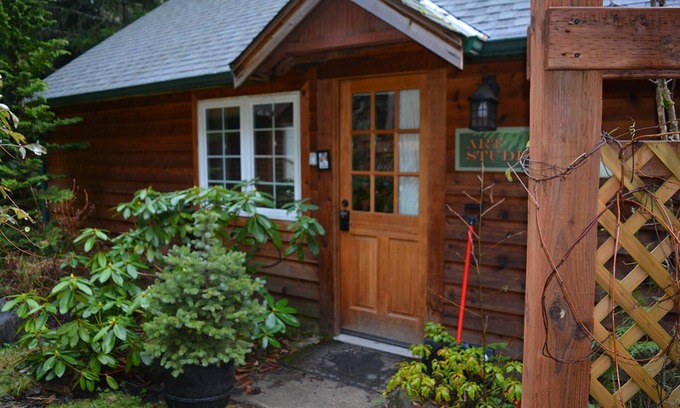 Ashford Cabin | This romantic cabin at Mt. Rainier is a one room cabin with private hot tub right on Copper Creek. It has a queen bed and a queen Murphy bed. Walk to Copper Creek Restaurant. Beautiful woodland setting.