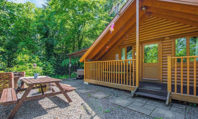 Westleigh Ski Chalet | Timber lodge set in an elevated woodland position with views of the lake.