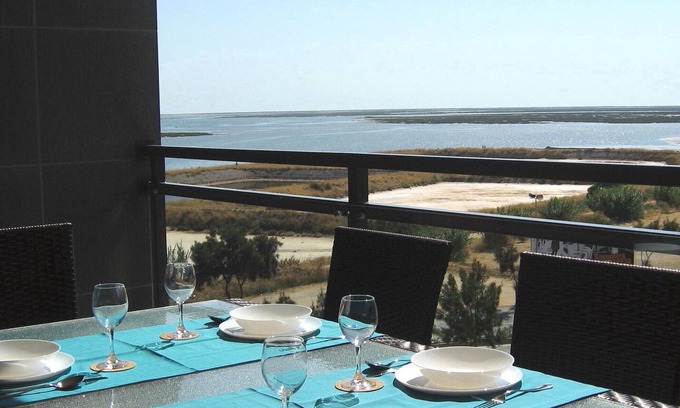 Olhao Apartment | Top-floor frontline apartment, sea views, rooftop pool, easy walk historic Olhao