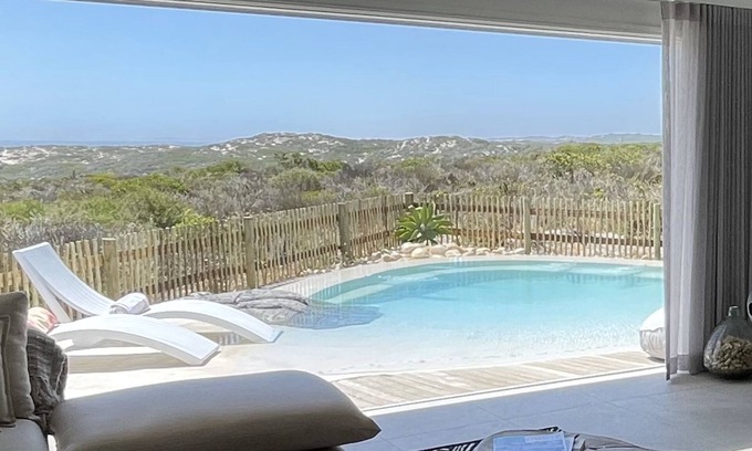 Grotto Bay House | Tranquil haven: home in nature's embrace, where ocean and dunes unite.