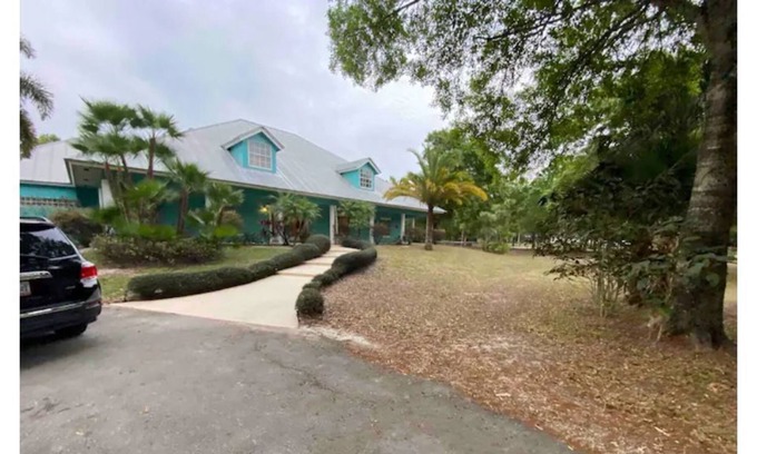 Palm City House | Tropic Retreat! Pool, 3 acres, pond, 4500sq ft
