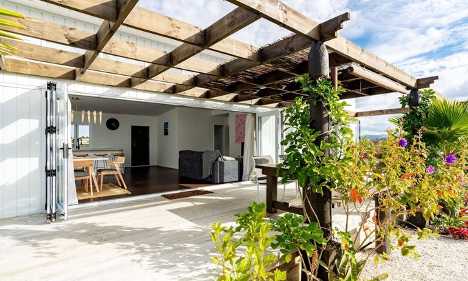 Mangawhai Heads House | Tropical Oasis - Modern, sunny, fully fenced holiday home with beautiful tropical gardens