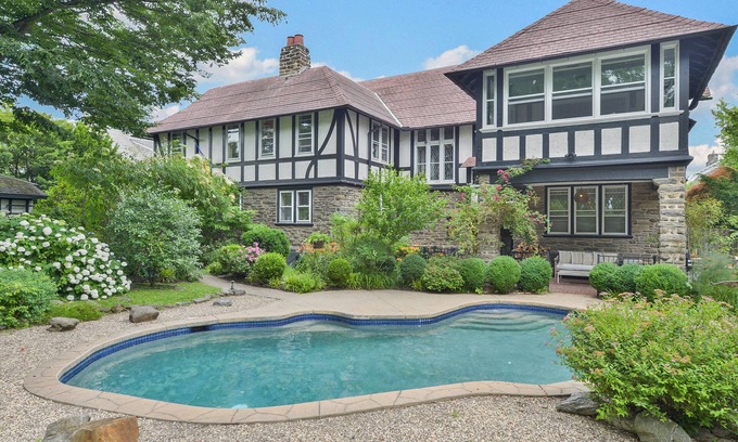 West Mount Airy Villa | Tudor Mansion With Outdoor Oasis and Swimming Pool