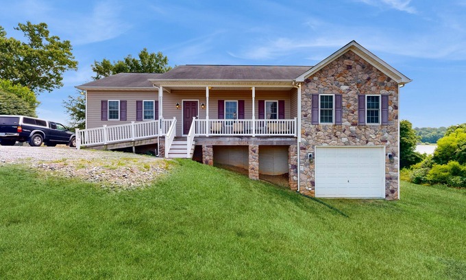 Orange House | Two-story, lakefront getaway with dock, beach, grill, 2 kayaks, 2 canoes, AC