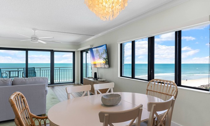 New Smyrna Beach Condo | Updated direct oceanfront corner condo with large wrap-around balcony and heated pool