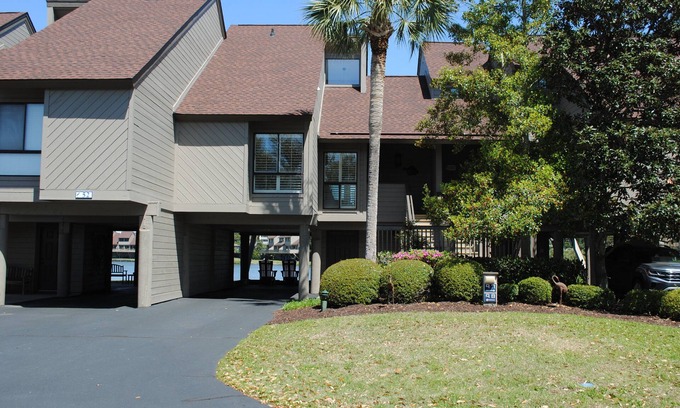 Litchfield by the Sea Condo | Villa with lake views and pool access located within gated Litchfield By the Sea community.