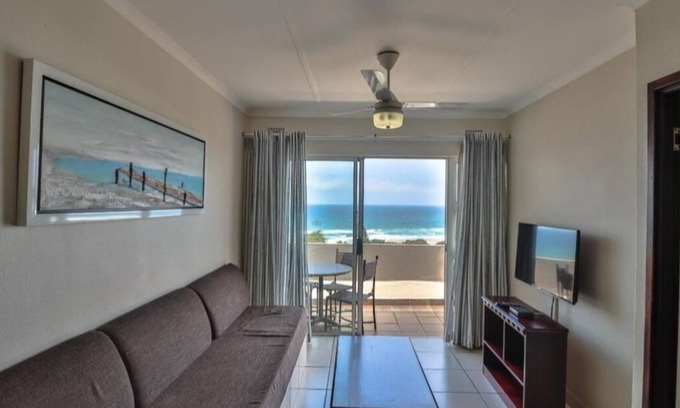 Illovo Beach Apartment | Wake up to the tranquil sight and sound of waves crashing against the shore.