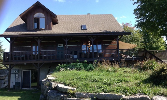 North Algona Wilberforce Cottage | Waterfront log home on Lake Dore. Decks, dock, outdoor hot tub and fire pit.