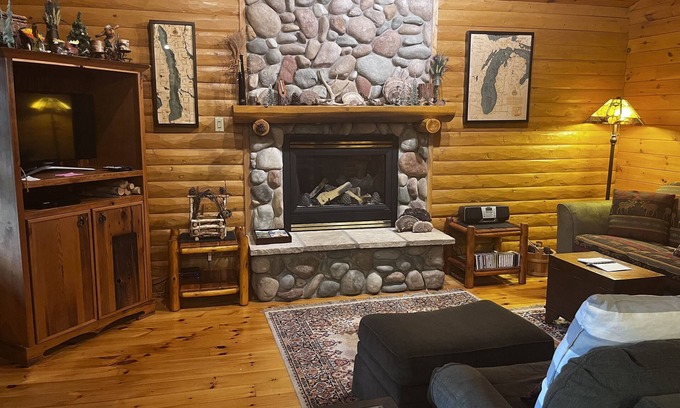 Bellaire Cabin | Waterfront log home on Lake Bellaire. Pet friendly. Fireplace, dock. dog ok
