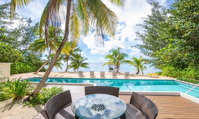 Breakers Villa | White Cottage: Deluxe Oceanfront Home w/Backyard Beachfront, Private Pool, Dock + Free Kayak
