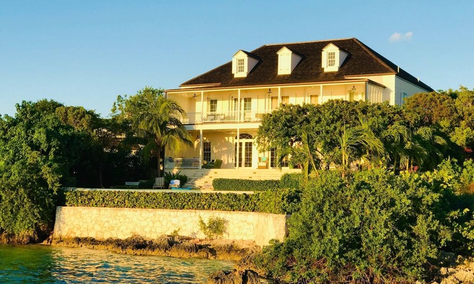 Dunmore Town Villa | Wind Whistle Harbour Villa- a classic Bahamian 2.5 story veranda-style house.