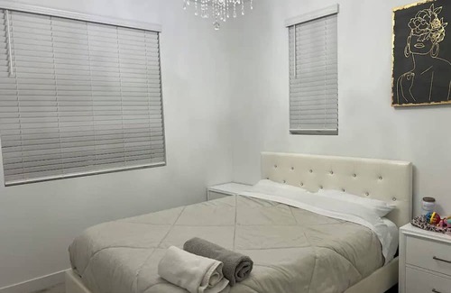 Upland House | Beautiful bedroom 02 with a private bathroom featuring a tub and shower.