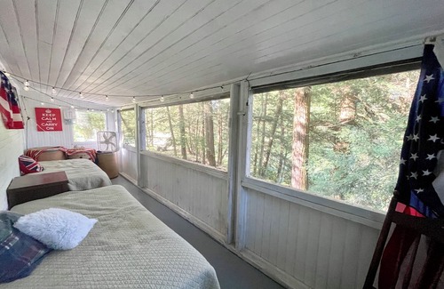 Greene Cottage | Rustic cottage surrounded by trees, overlooking a creek.