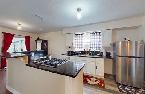 Casselberry House | Single-story home with community pool/tennis access, grill, patio, AC, & W/D