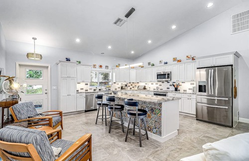 Pine Island Center House | Canal-side charmer with enclosed pool, waterside deck, open layout, & W/D