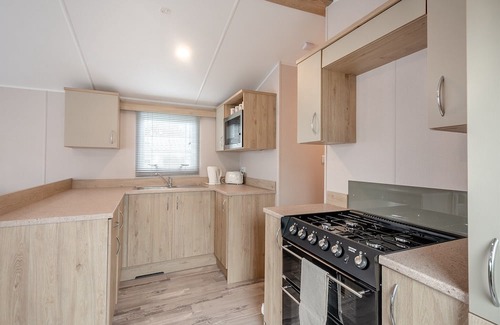 Sandyhills House | This spacious 2 bedroom caravan sleeps 4 people in one double and one twin bedroom.